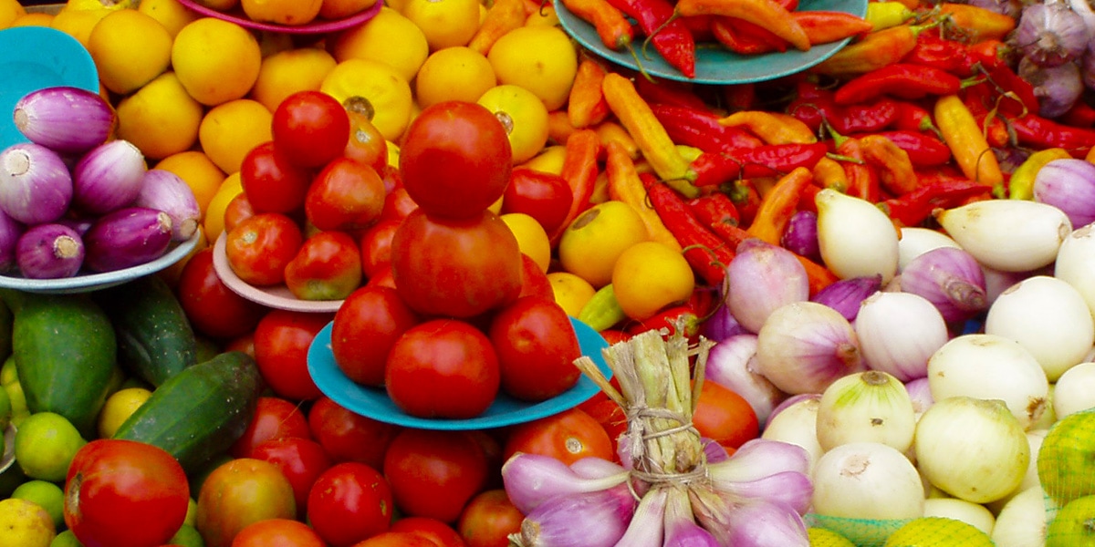 a market stall of fresh fruits and vegetables