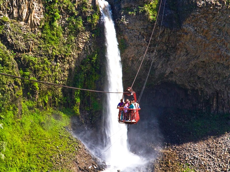 cablecar going over the pailon del diablo in baños, ecuador