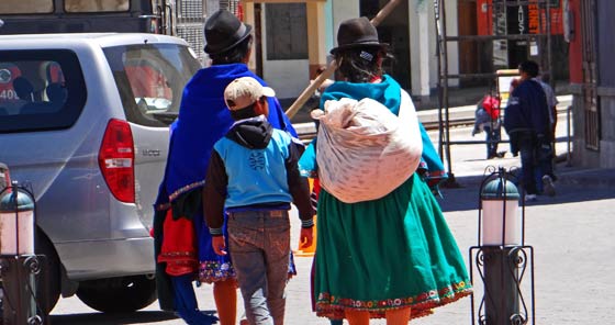 Women in traditional clothes walking in Alausí, Ecuador