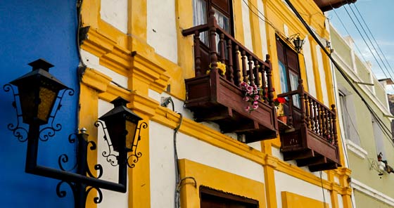 Yellow colonial building with wooden balcony in Alausí, Ecuador