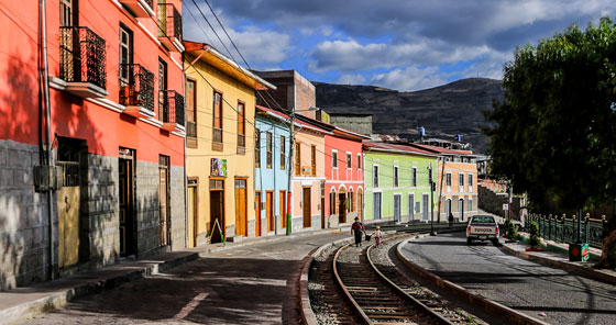 Twentieth century colorful buildings along railway tracks in Alausí, Ecuador