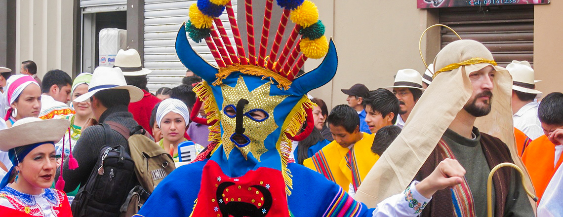 Man in a mask at the celebrations of Jueves de Compadres in Cuenca, Ecuador