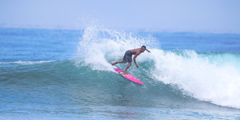 a surfer riding the waves in montañita, ecuador